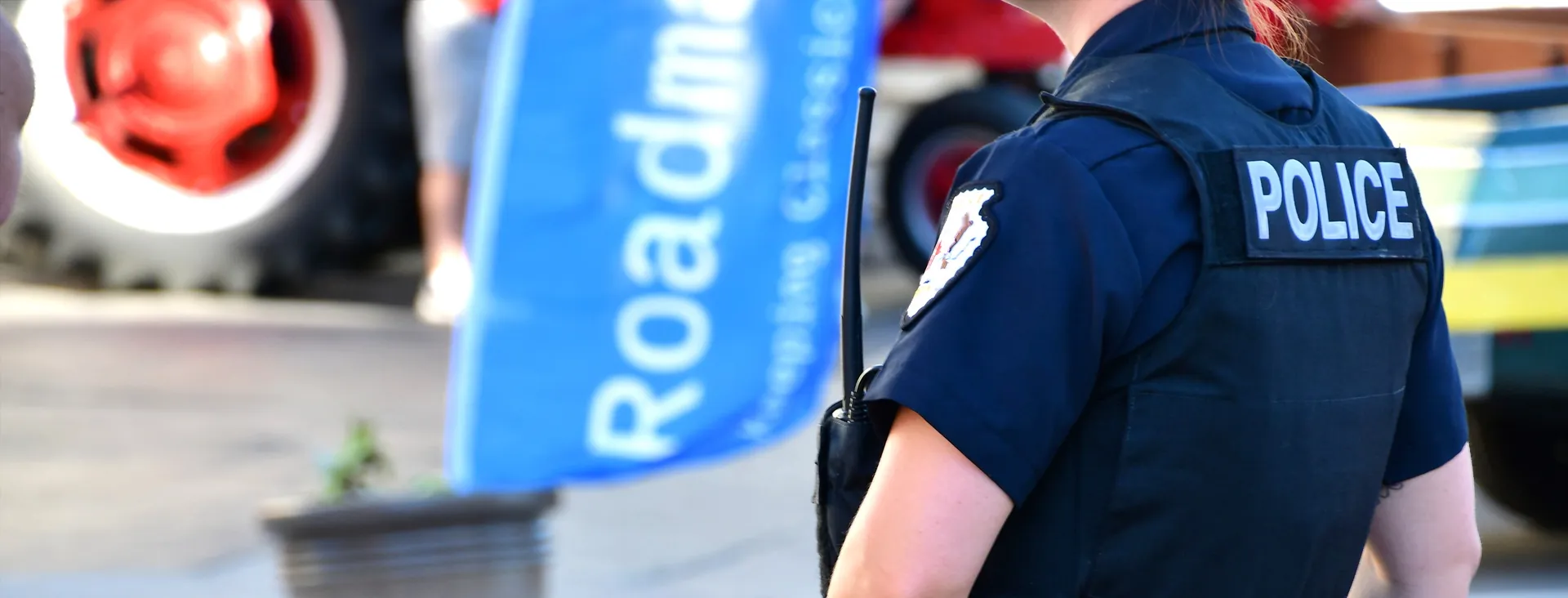 A uniformed police officer seen from behind