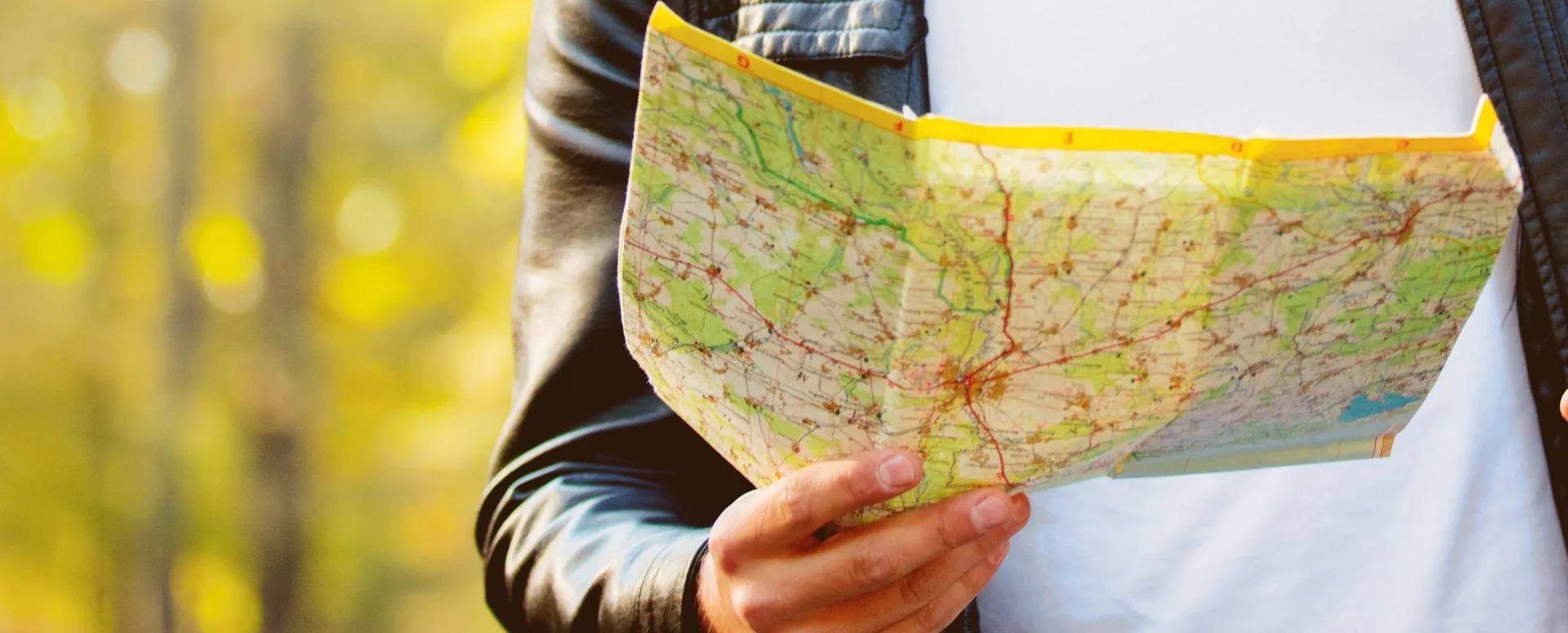 A person reading a folded road map